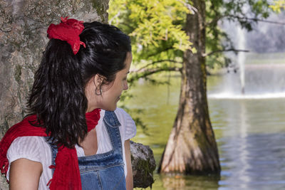 Woman looking at lake in park