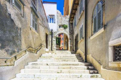 Low angle view of steps amidst buildings