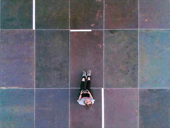 Directly above shot of man sitting on floor