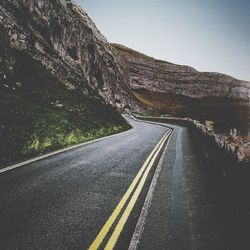 Empty road with mountain in background