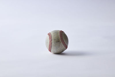 Close-up of ball on table against white background