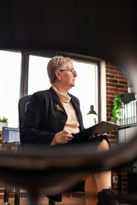 Portrait of businesswoman using mobile phone in office