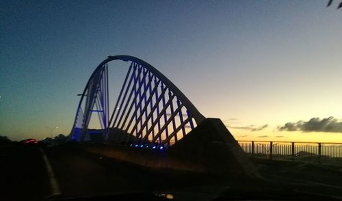 Bridge against clear blue sky during sunset