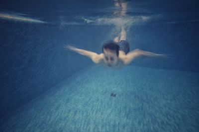 Man swimming in pool