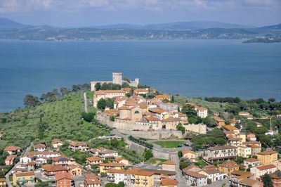 High angle view of townscape by sea against sky