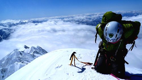 Scenic view of snow covered mountain against blue sky