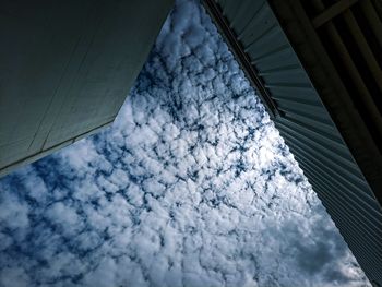 Low angle view of glass building against sky