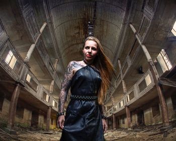 Fashionable of woman standing in abandoned building