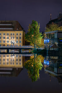 Reflection of illuminated buildings in water at night