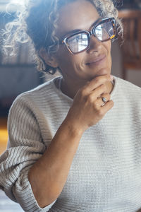 Portrait of woman holding sunglasses