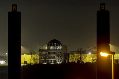 Illuminated city against sky at night