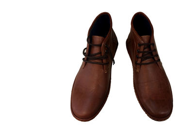 Close-up of brown shoes over white background