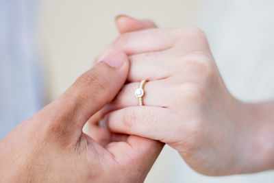 Close-up of couple holding hands