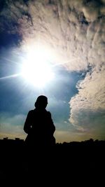 Silhouette of man against cloudy sky