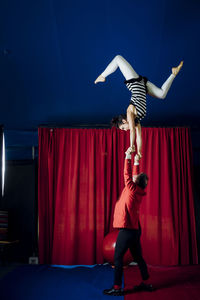 Male and female acrobats performing together in circus