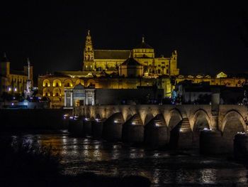 Reflection of illuminated buildings in water at night