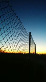 Silhouette metal against sky during sunset