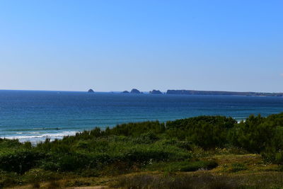 Scenic view of sea against clear blue sky