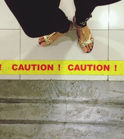 Low section of woman standing on wall