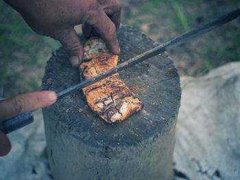 Midsection of man working on metal