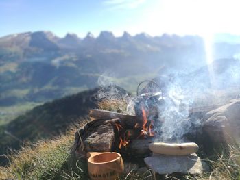 Close-up of bonfire against mountain range