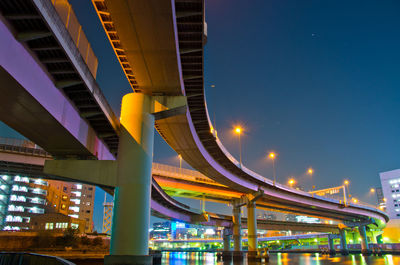 Low angle view of illuminated buildings against sky at night