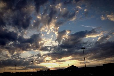 Silhouette of building against cloudy sky