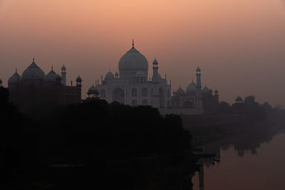 Low angle view of mosque against sky during sunset