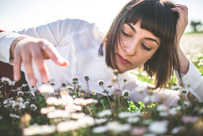 Young woman relaxing on flowers field