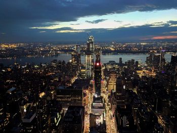 High angle view of illuminated city buildings against sky