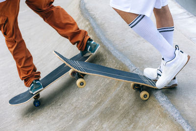 Friends with skateboards in skate park