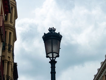 Low angle view of street light against building