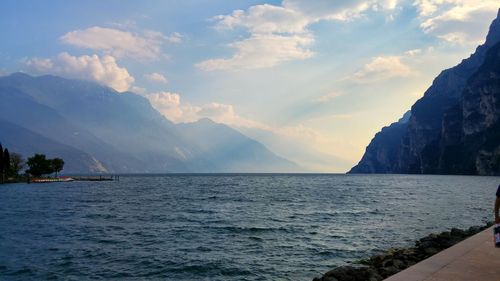 Scenic view of sea and mountains against sky