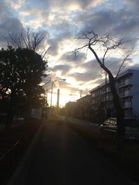 Empty road against cloudy sky