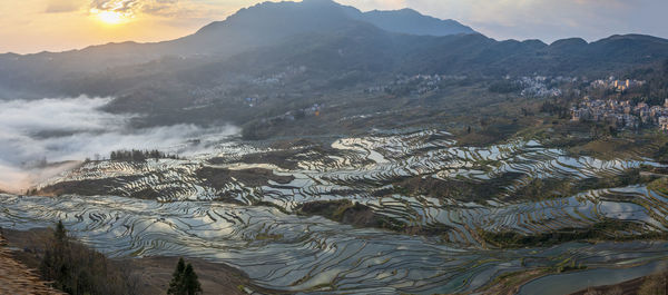 Scenic view of mountains against cloudy sky