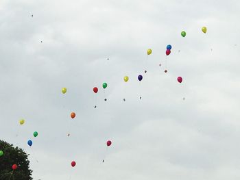 Low angle view of balloons against sky