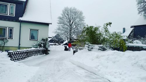 View of snow covered houses and buildings in city