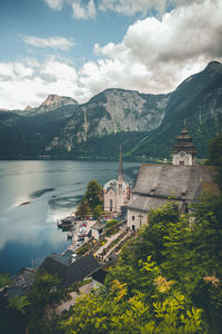 Church at lakeshore against mountains