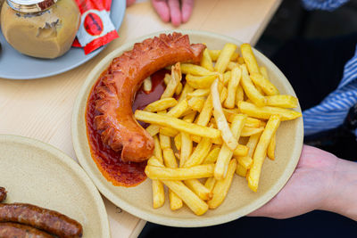 Cropped hand of person holding food