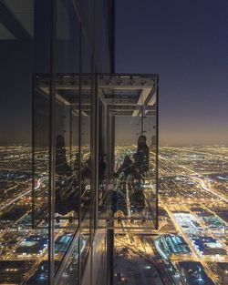 Illuminated cityscape against clear sky at night