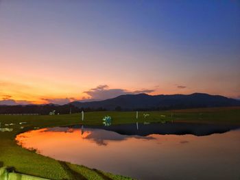 Scenic view of lake against romantic sky at sunset