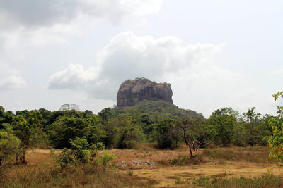 Rock formations on landscape against sky