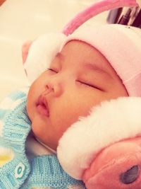 Close-up of baby sleeping on bed