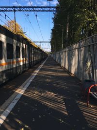 Train at railroad station platform against sky