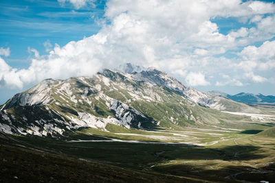 Scenic view of mountain against clouds and sky