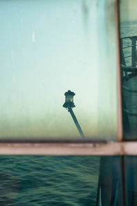 Cropped image of man standing by sea against sky