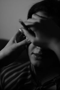 Close-up portrait of woman smoking at home