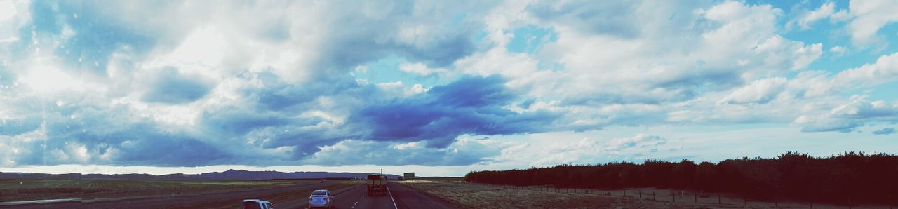 transportation, sky, the way forward, cloud - sky, road, diminishing perspective, cloudy, vanishing point, cloud, landscape, nature, tranquil scene, tranquility, road marking, blue, land vehicle, scenics, car, mode of transport, beauty in nature