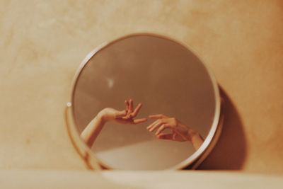 Reflection oh hands on mirror