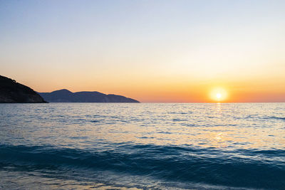 Scenic view of sea against clear sky during sunset